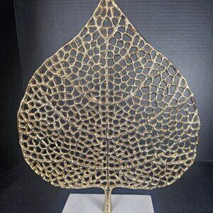 Gold Finish Metal Ficus Leaf Sculpture On A White Marble Base